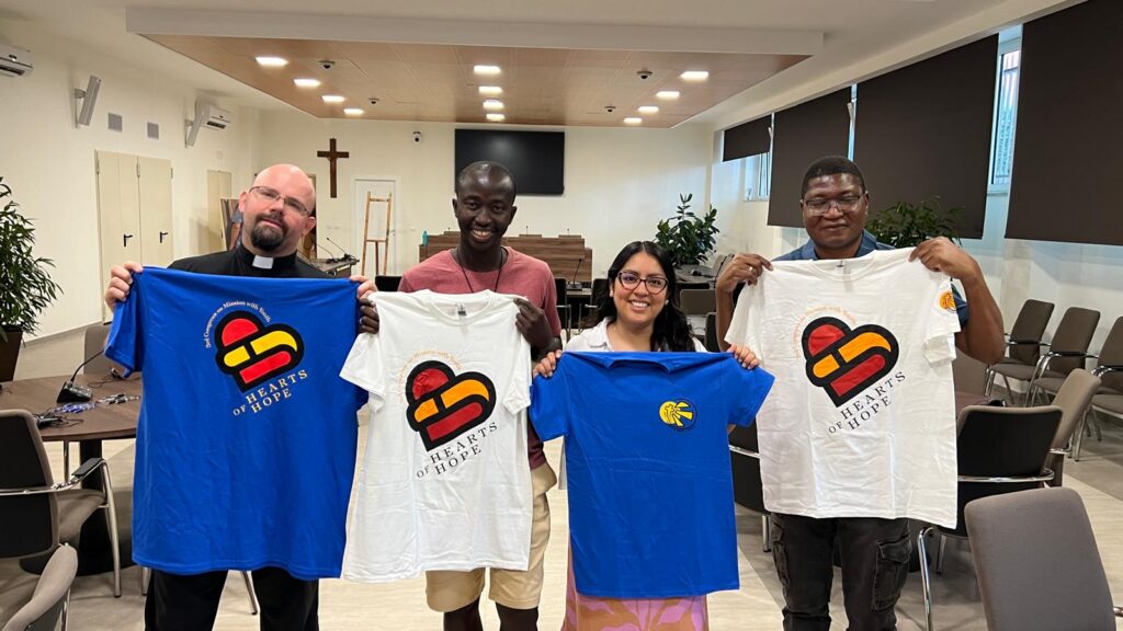 Customers displaying completed custom screen-printed shirts produced by Ugly Guppy